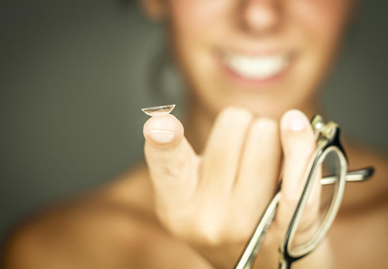 Woman Holding a Contact Lens on Her Finger